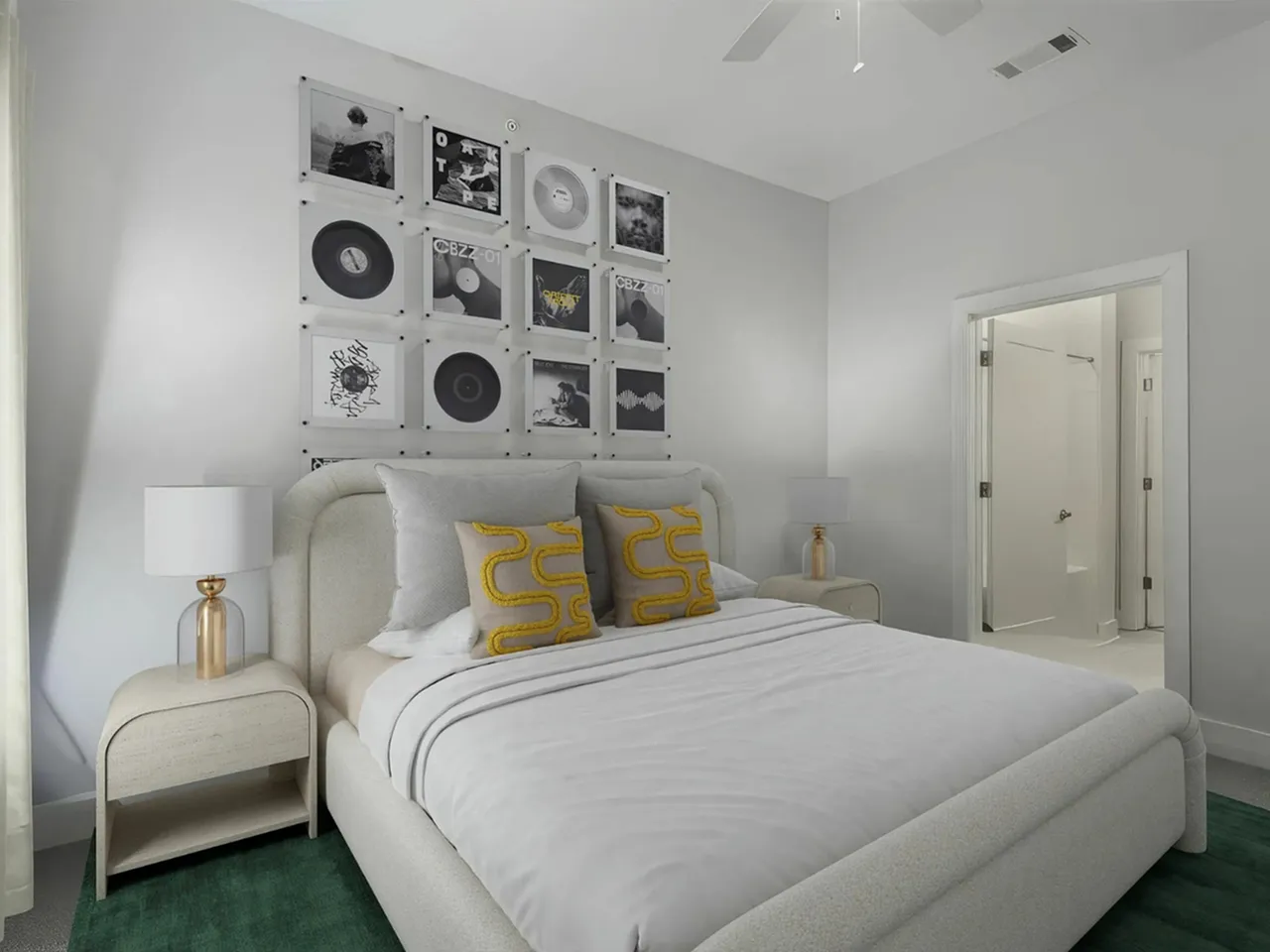 Modern bedroom with elegant decor, featuring a cozy bed, artistic wall art, and a private ensuite bathroom at The Melrose Apts in South Nashville.