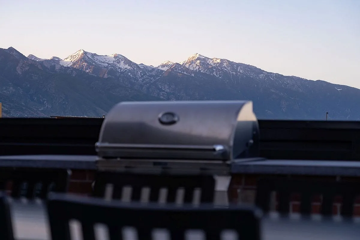 Chic rooftop BBQ area with stunning mountain views perfect for outdoor entertaining at The Richmond Apartments in Millcreek