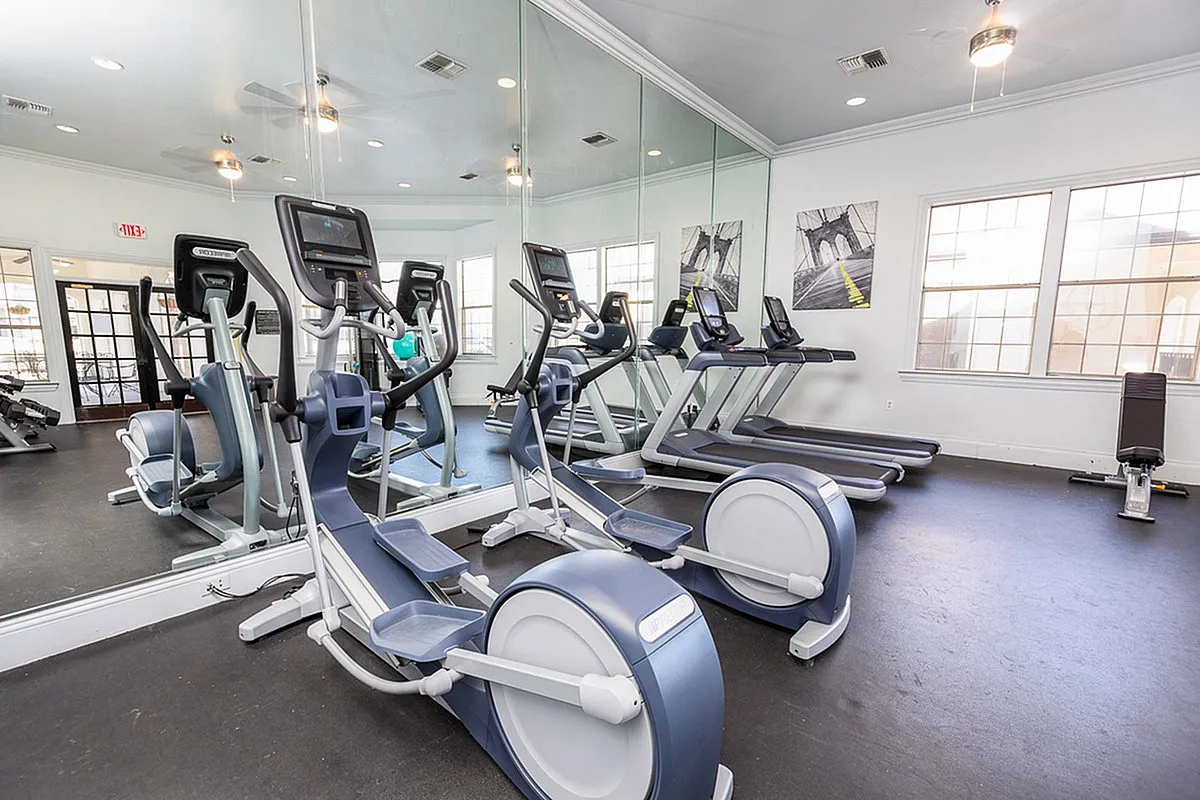 Stonebriar of Frisco's bright and modern gym featuring state-of-the-art elliptical machines and treadmills, perfect for a dynamic workout experience.