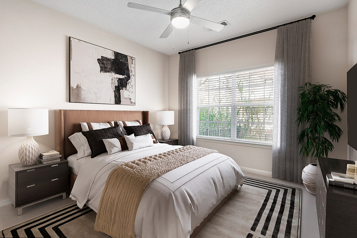 Elegant bedroom at Summer Park Apartments featuring a cozy king-size bed, modern decor, and soft natural lighting through large windows.