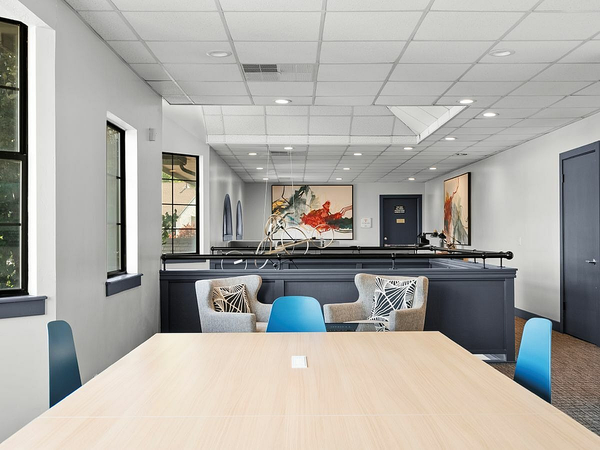 Chic co-working space with modern art, stylish seating, and ample natural light  at Apt CoWork at Cottonwood Apartments in Salt Lake City