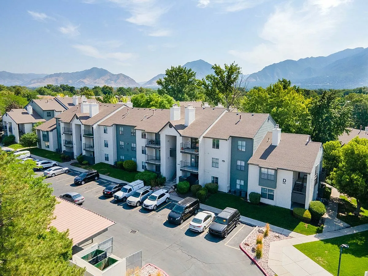 Charming apartment complex surrounded by lush greenery and mountain views, featuring ample parking and a peaceful neighborhood vibe at Cottonwood Apartments in Salt Lake City