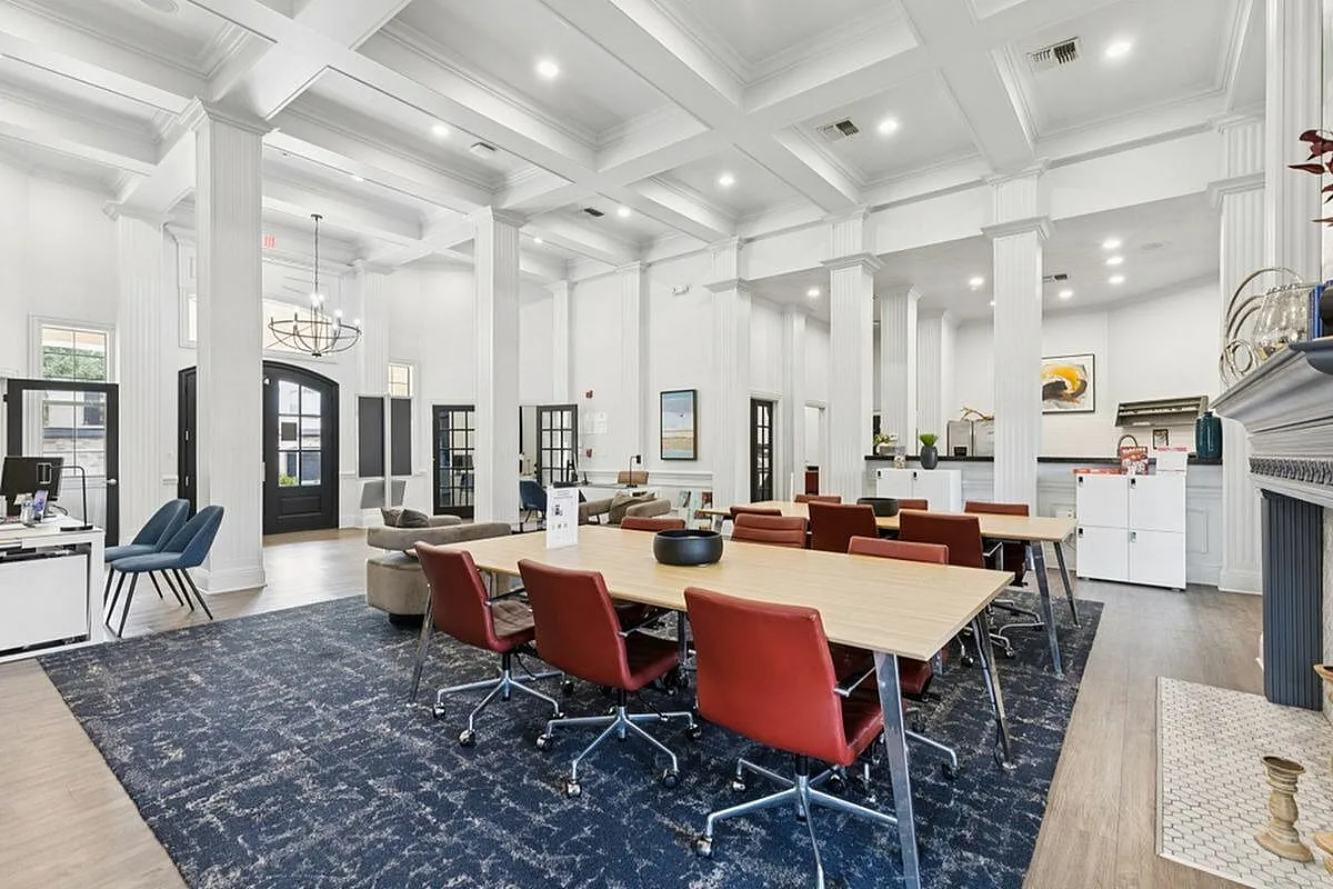 Elegant co-working space with high ceilings, plush seating, and modern decor, perfect for productivity and collaboration at Stonebriar at Frisco Apartments