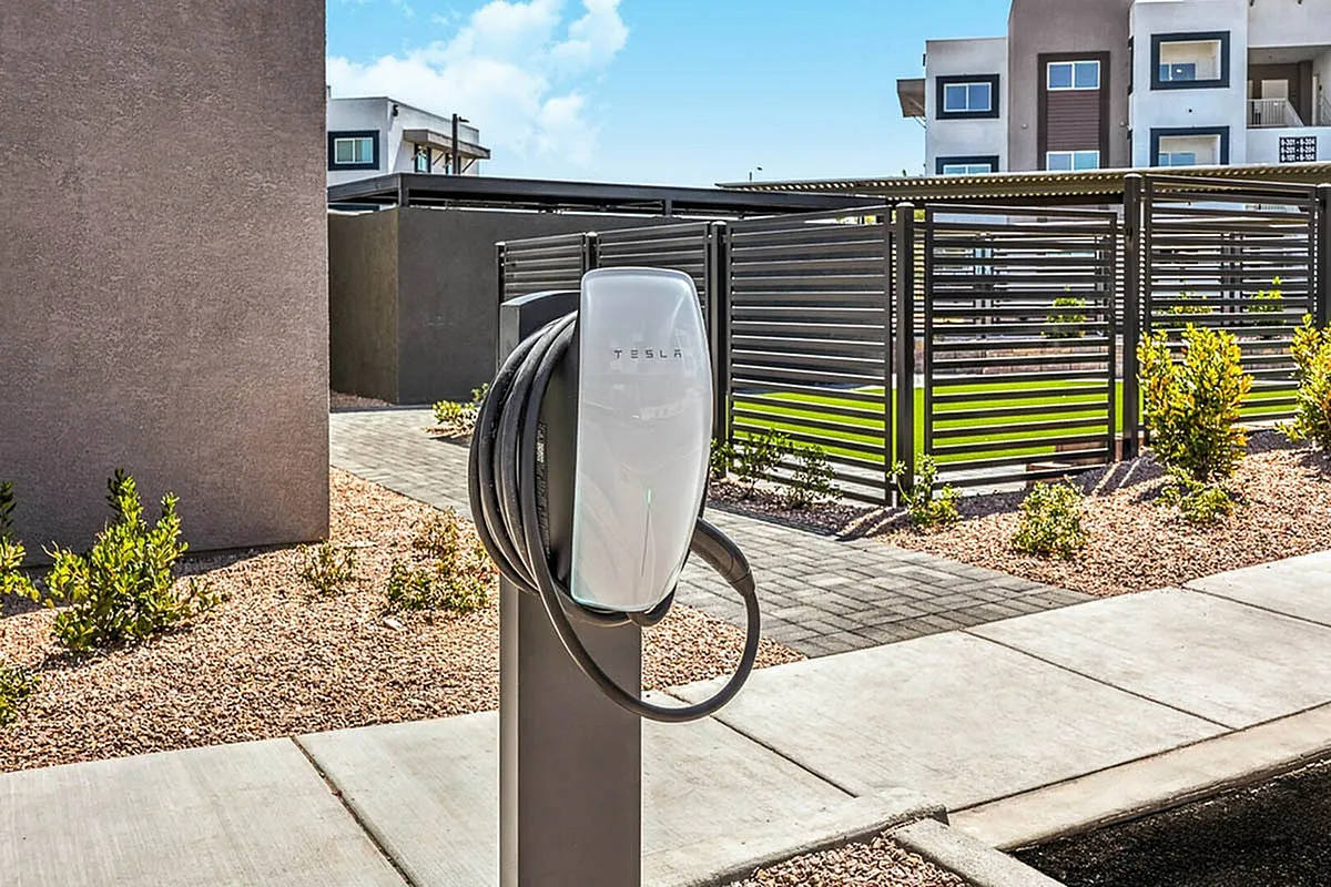 Modern apartment complex featuring electric vehicle charging station with elegant landscaping, showcasing eco-friendly living and convenient amenities at Summit on Boulder Apartments.