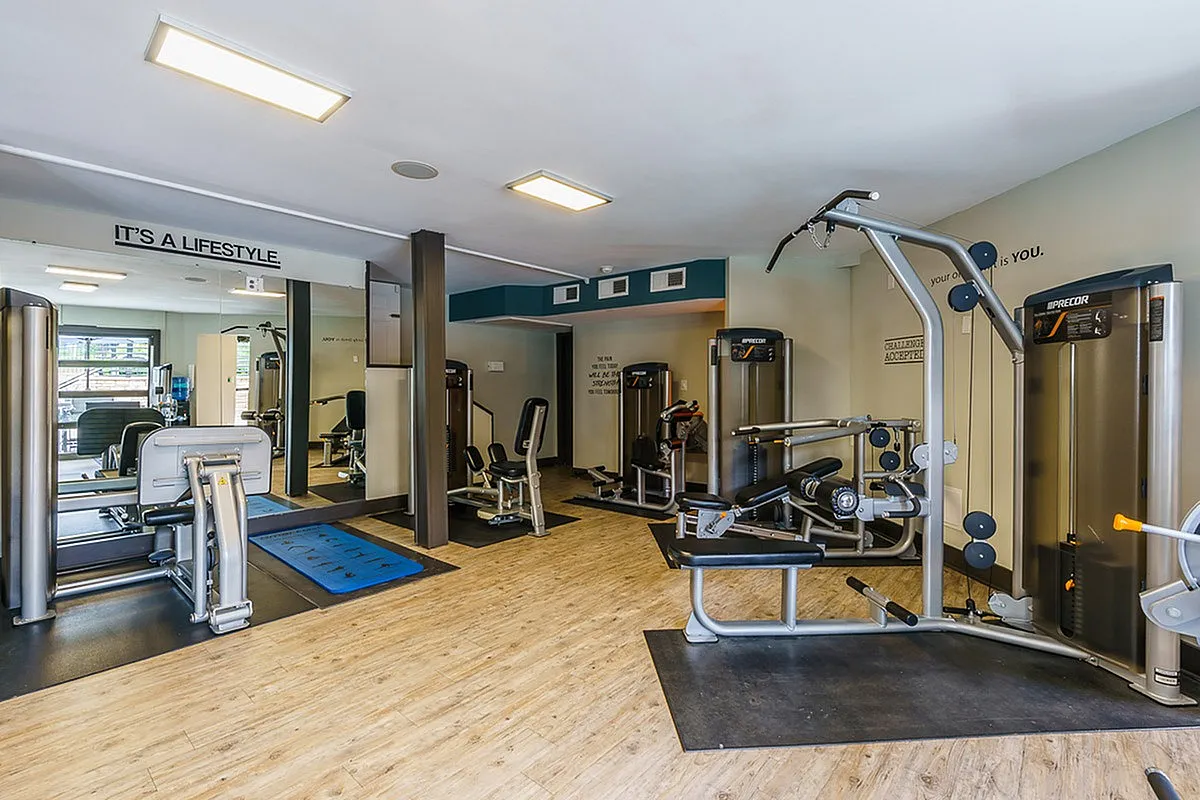 Modern fitness center at The Creeks on Kirklevington Apartments with state-of-the-art equipment and bright, welcoming atmosphere promoting a healthy lifestyle.