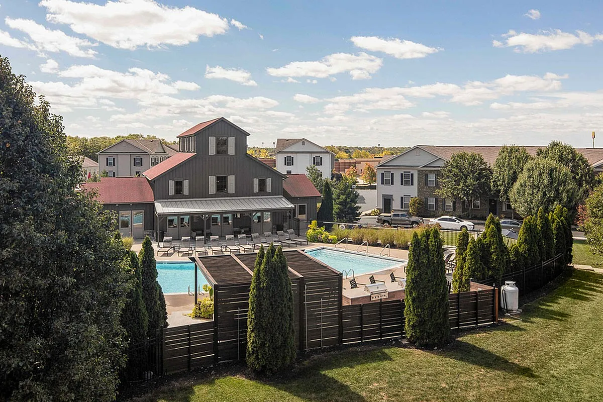 Charming residential community with a stylish clubhouse, inviting swimming pool, and lush landscaping, perfect for modern living at The Mill at Georgetown Apartments.