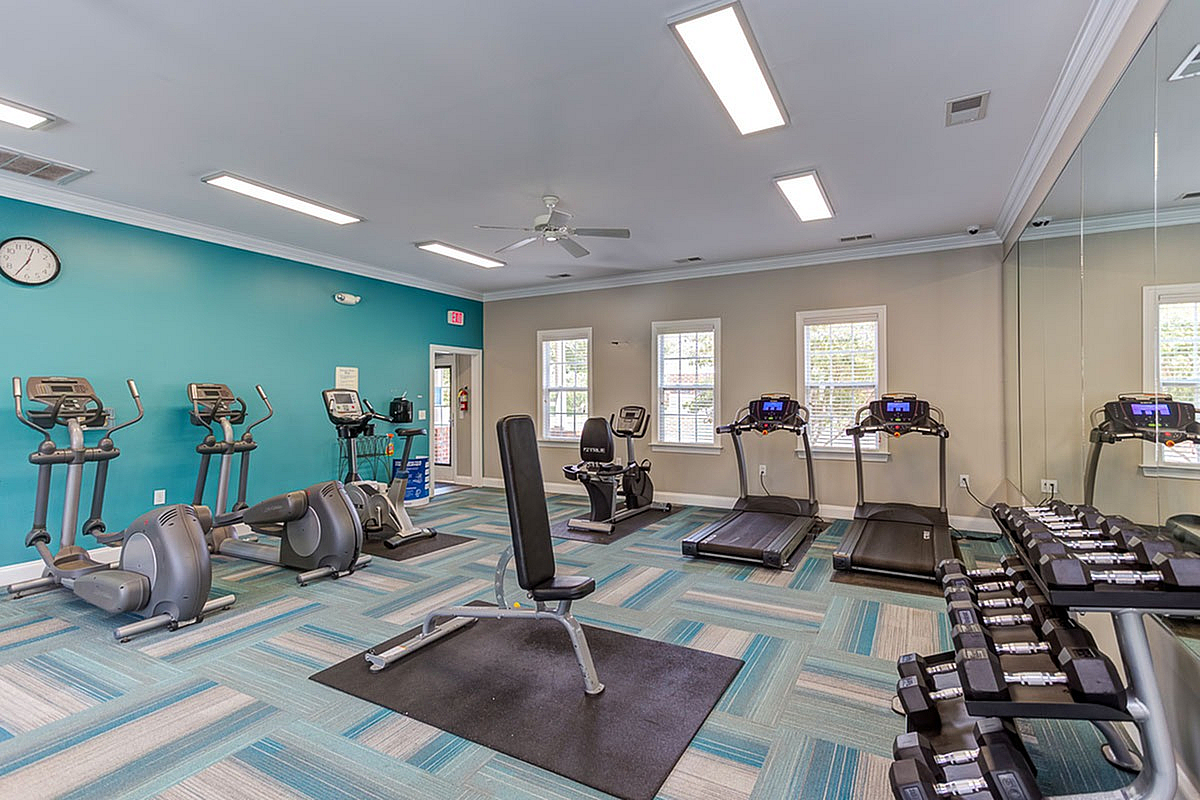 Modern fitness center at Morgan Ridge Apartments with state-of-the-art equipment and vibrant design for an energetic workout experience.