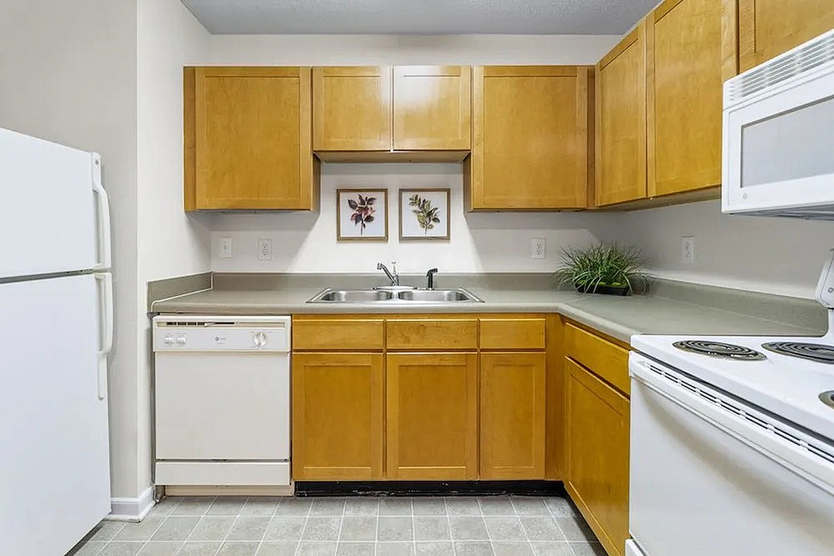 Charming kitchen at Morgan Ridge Apartments with warm wood cabinets, modern appliances, and elegant decor, perfect for home chefs.