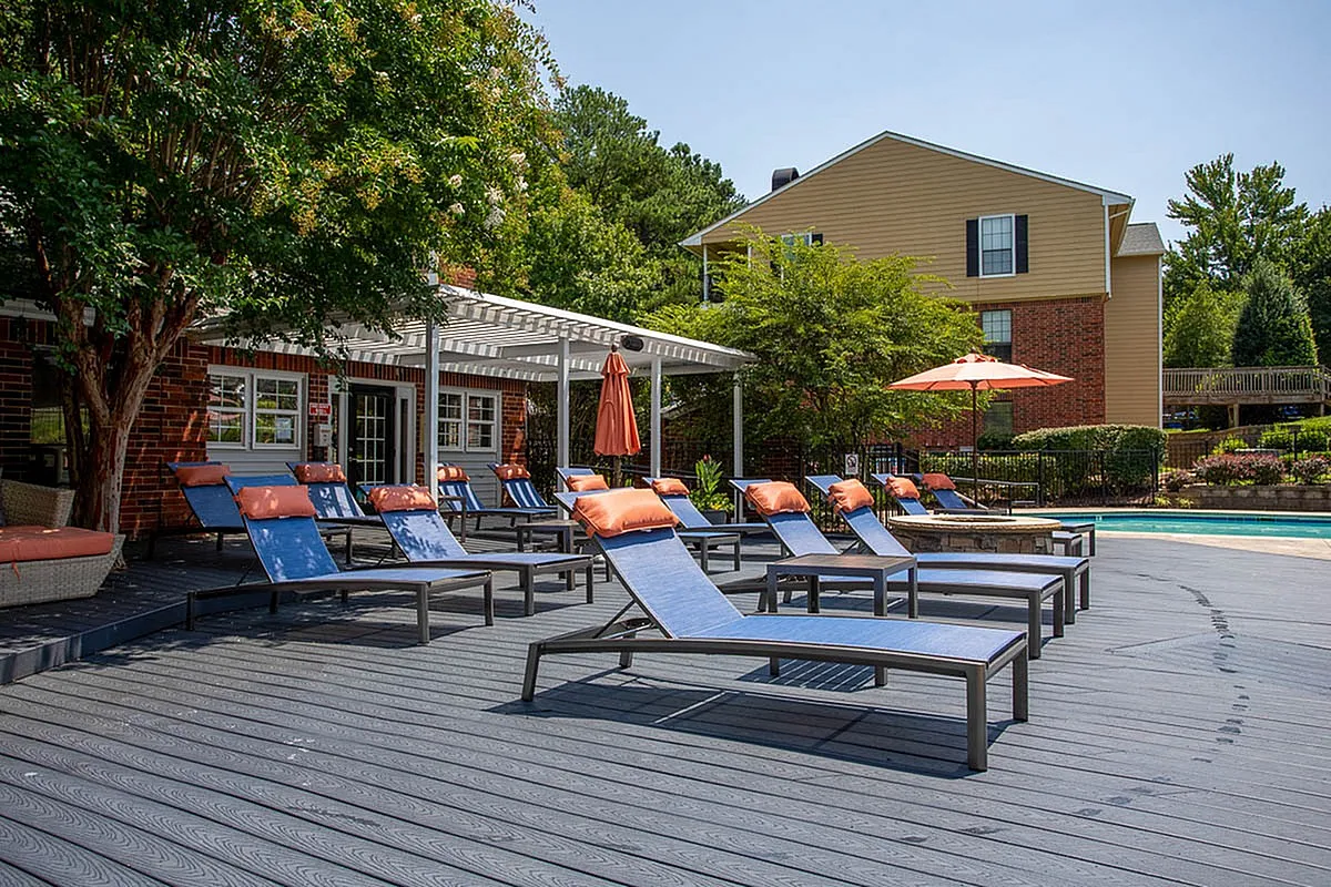Inviting poolside oasis featuring stylish lounge chairs and vibrant umbrellas perfect for relaxation at Autumn Ridge Apartments.