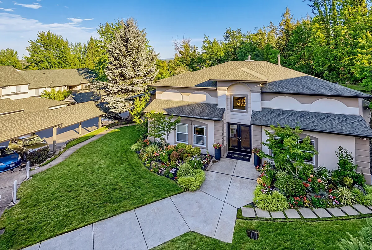Charming suburban home with lush landscaping, vibrant flower gardens, and inviting curb appeal nestled in a serene neighborhood at Scott Mountain Apartments in Portland OR.