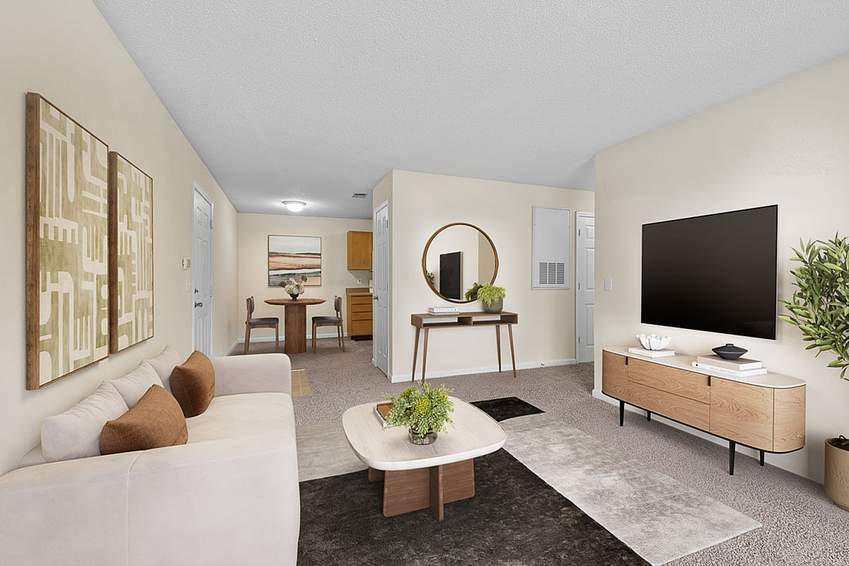 Elegant open-concept living space with cozy furnishings, rich decor accents, and a view into the stylish dining area.