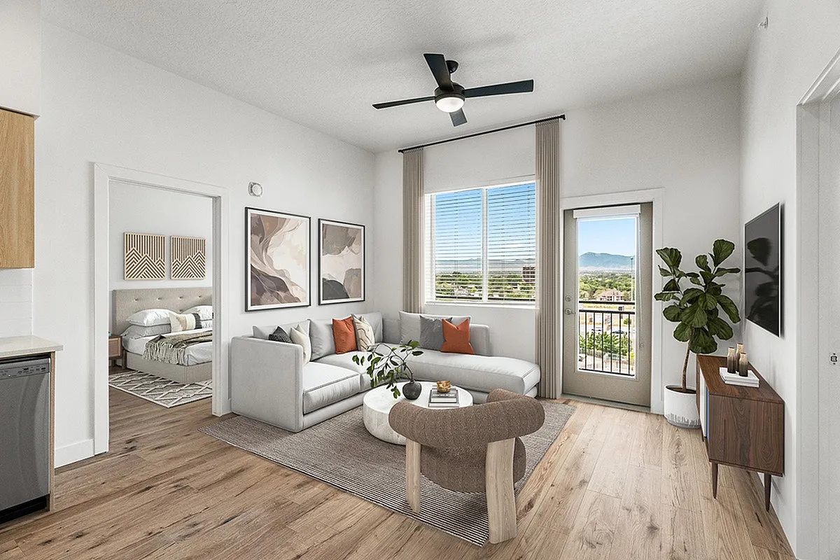 Bright, modern living room with stylish decor, open layout, and mountain view from the balcony.