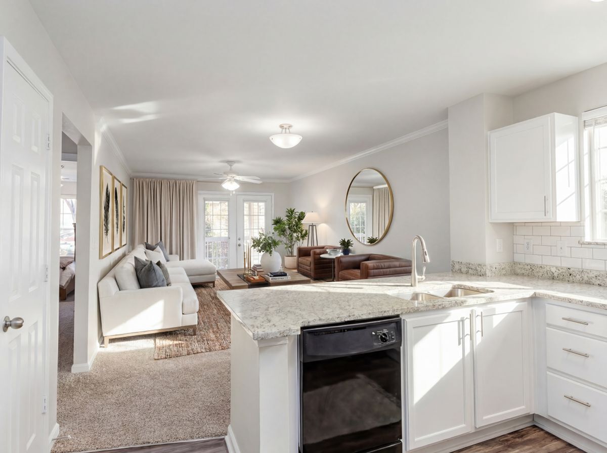 Bright and modern living space featuring an open-concept kitchen with granite countertops, cozy seating area, and sleek decor.