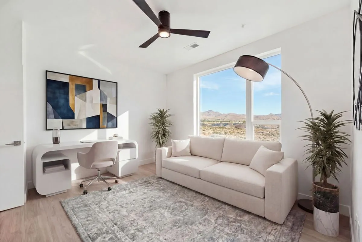 Bright and airy home office with elegant desk, cozy beige sofa, and stunning mountain view, perfect for inspiration.