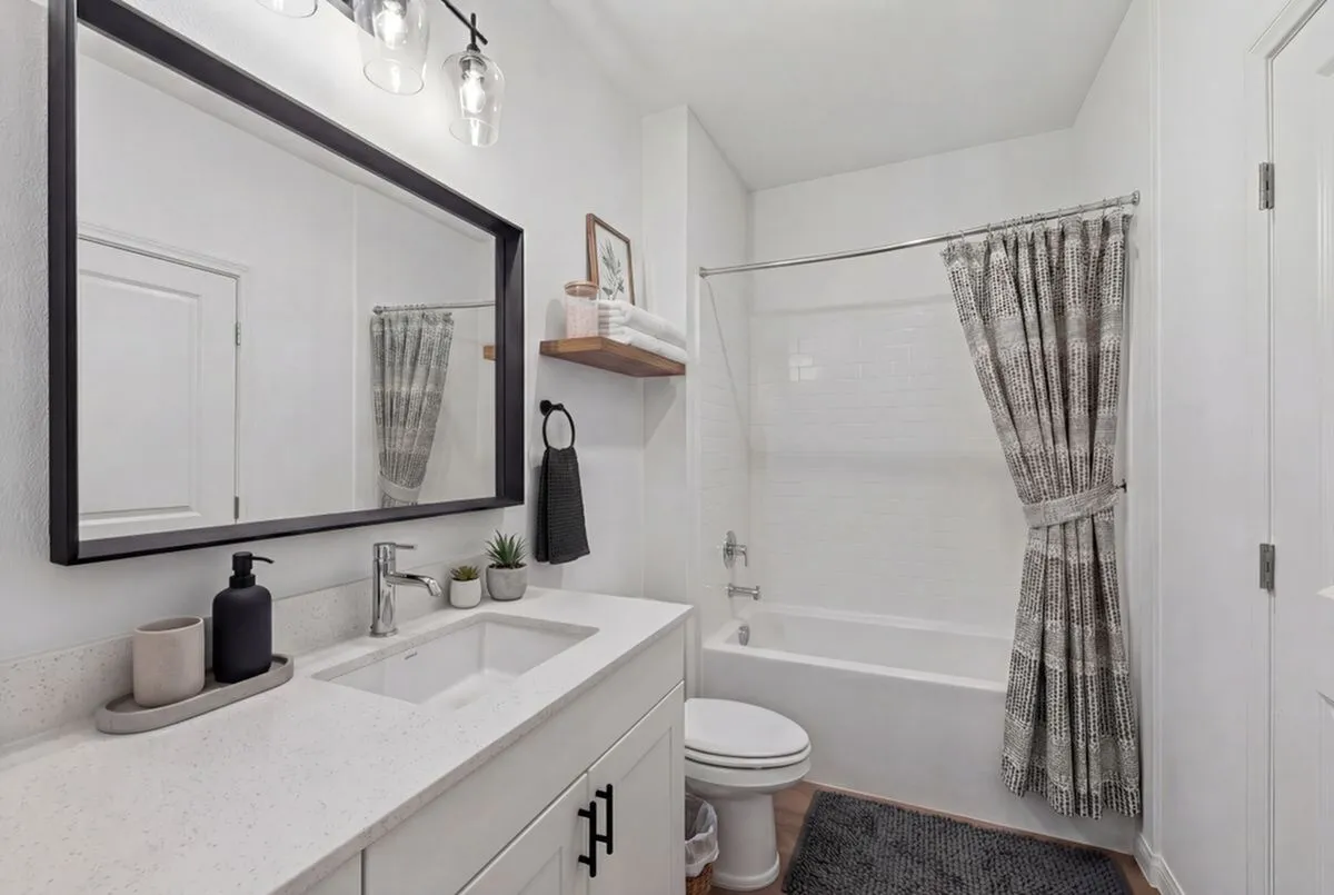 Sleek modern bathroom with elegant fixtures, chic vanity, and contemporary tile design.