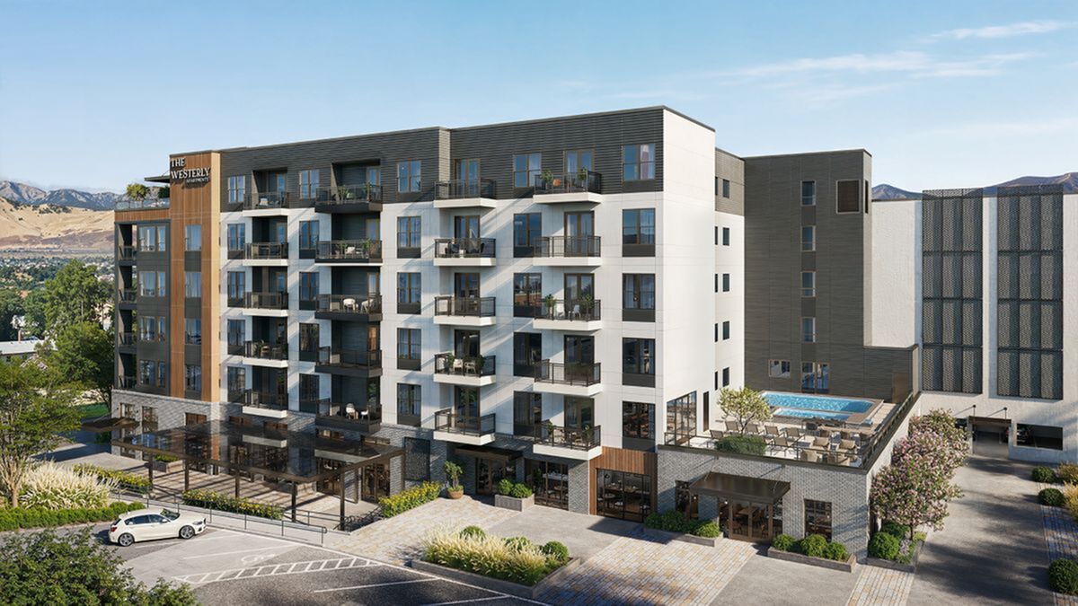 Modern apartment complex with spacious balconies, a rooftop pool, and scenic mountain views at The Westerly in Millcreek Commons