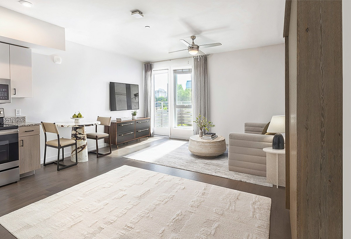 Bright and modern living space with open-concept design, stylish furniture, large window, and elegant decor.