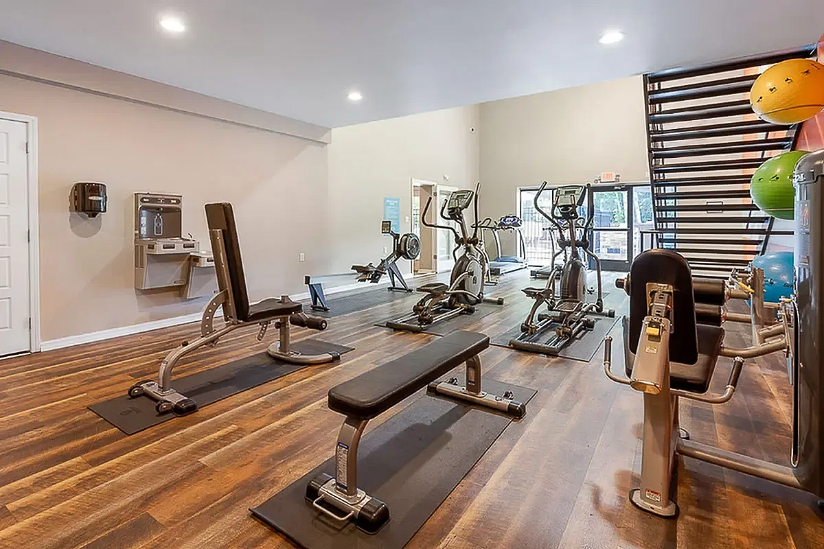 Modern fitness center at Park at Oak Ridge Apartments featuring state-of-the-art gym equipment and natural lighting, perfect for a healthy lifestyle.