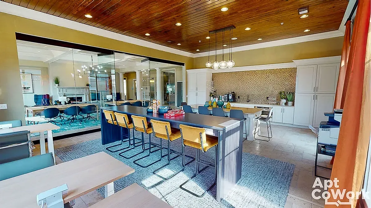 Elegant coworking space at Heights at Meridian with a sleek communal table, modern lighting, and chic decor for creative collaboration.
