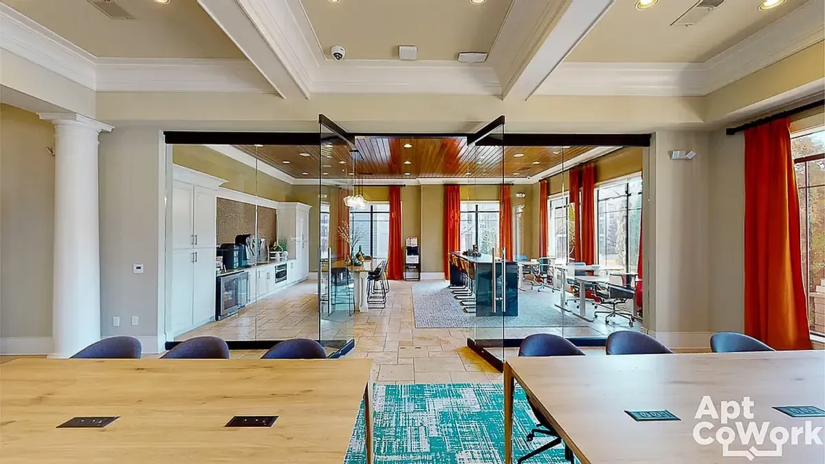 Modern co-working space at Heights at Meridian Apartments with sleek glass walls, vibrant curtains, and ample natural light accentuating a sophisticated conference area.
