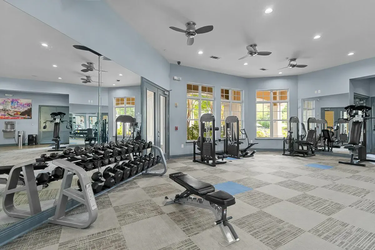 Modern fitness center with state-of-the-art equipment, free weights, and spacious, well-lit atmosphere at Cottonwood Reserve in Charlotte, NC