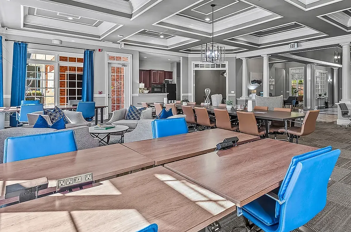 Luxurious and inviting shared workspace featuring elegant seating, modern lighting, and a spacious meeting area. Ideal for social gatherings and productivity at Retreat at Peachtree City Apartments.