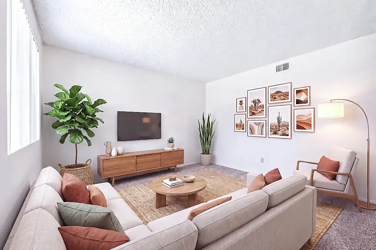 Chic living room with modern decor featuring cozy sectional sofa, stylish gallery wall, sleek media console, and vibrant green plants.