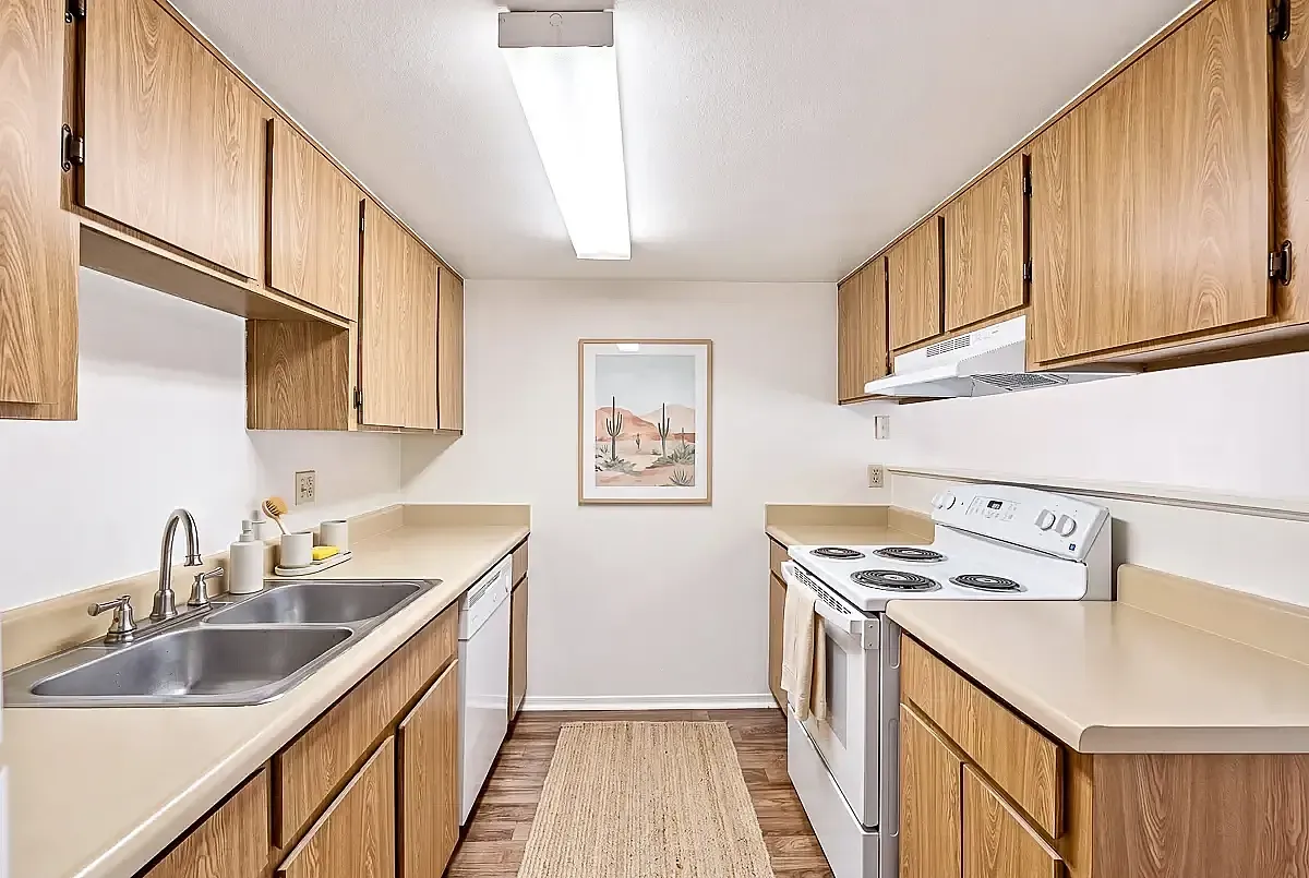 Contemporary kitchen with sleek wooden cabinetry, modern appliances, and stylish countertop design.