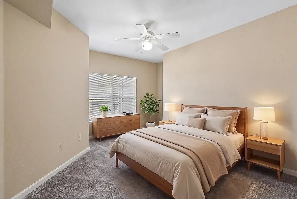 Inviting bedroom featuring a plush bed, modern wooden furniture, and soft lighting perfect for a cozy retreat at Cason Estates Apartments in Murfreesboro, TN.