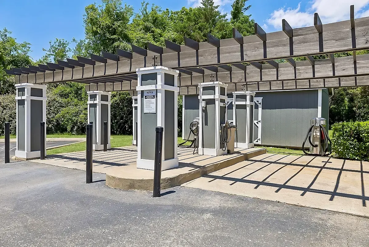 Charming outdoor car care station at Cason Estates in Murfreesboro, TN featuring wooden pergola and lush greenery, perfect for convenient vehicle maintenance.