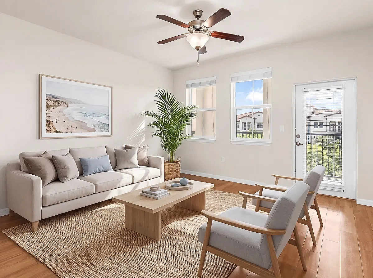 Bright and inviting living room with modern decor, elegant furniture, and natural light streaming through large windows; ideal for relaxation and entertaining.