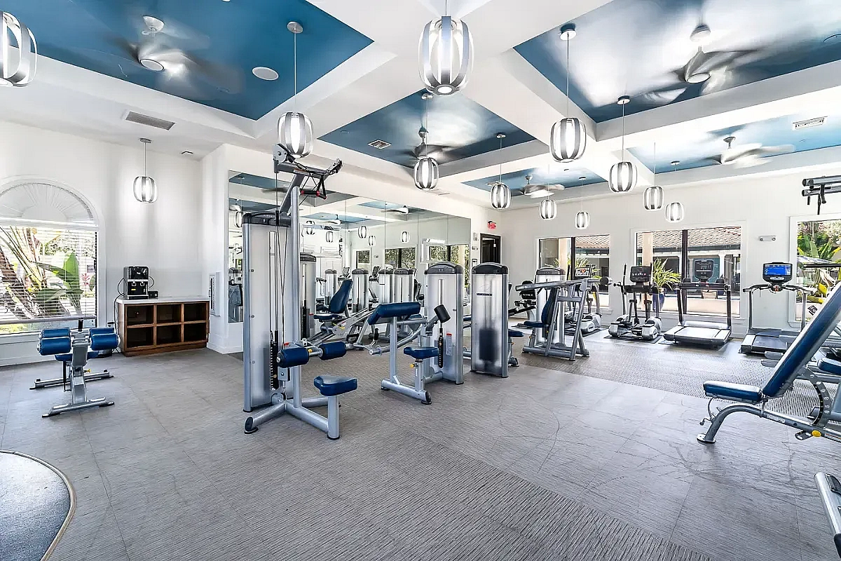 Modern fitness center with state-of-the-art equipment, sleek design, and natural lighting.