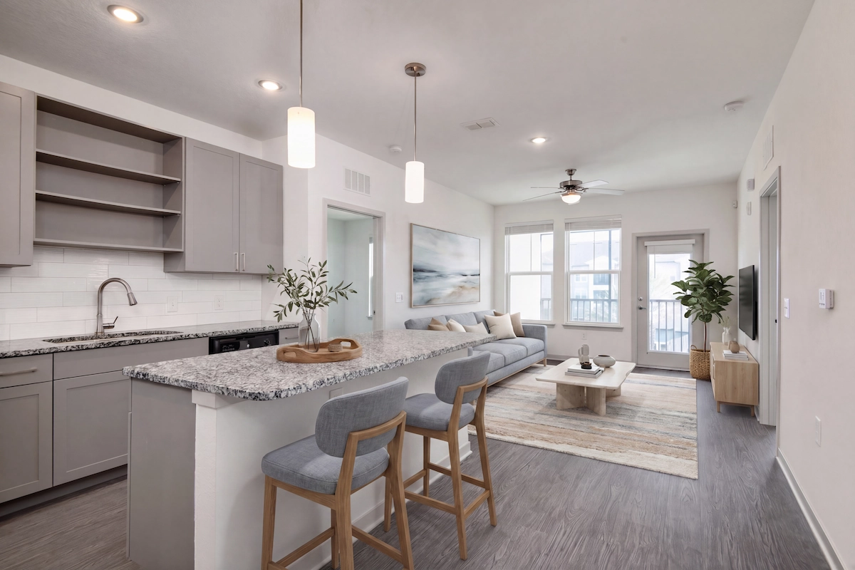 Bright and modern apartment home at Cottonwood Clermont Apartments, Clermont, Florida, showcasing an open floor plan with a gourmet kitchen, breakfast bar, comfortable living area, natural light, and access to a private balcony.