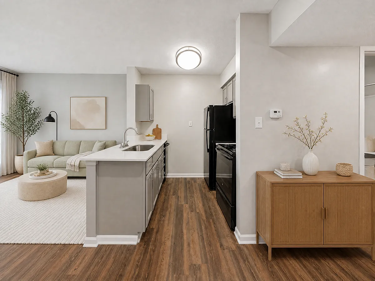 Contemporary open-concept living space with stylish kitchen, elegant wood flooring, and cozy seating area perfect for entertaining.
