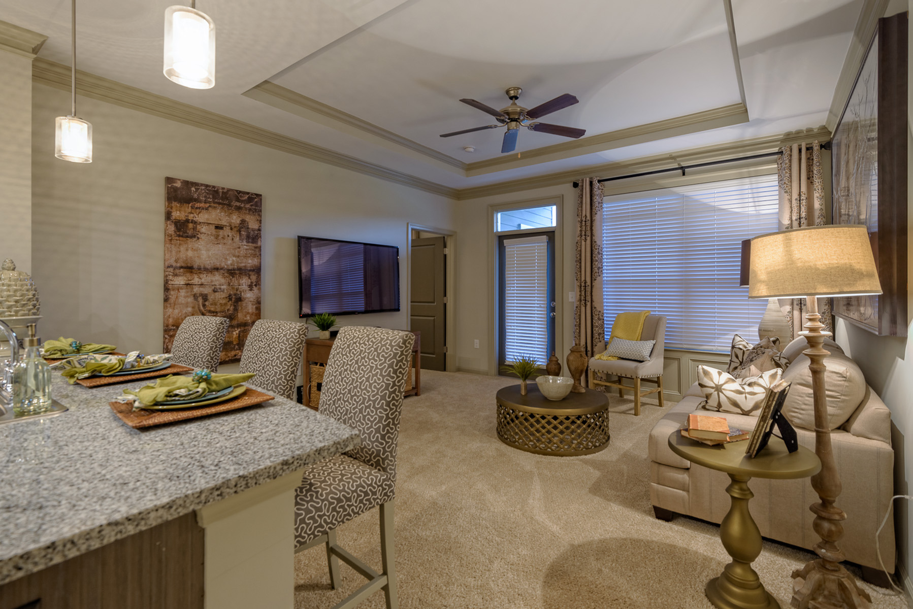 View of Living Room, Showing Bar Stools, Ceiling Fan, and Window View at Heights at Meridian Apartments