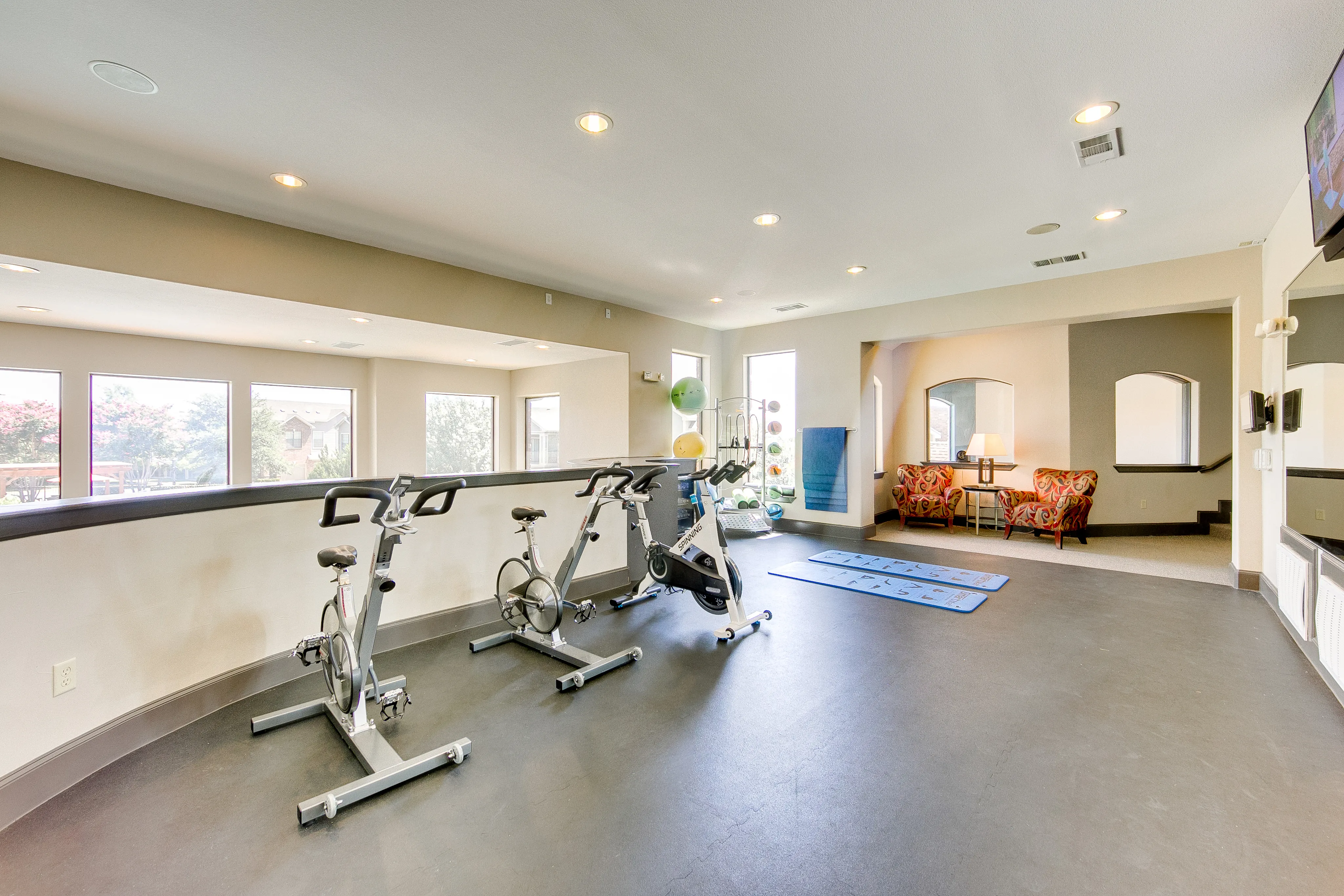 View of 2nd Floor Spin and Yoga Room, Showing Bikes, Mats, Mirrors and Flat Screen TV at Enclave on Golden Triangle Apartments
