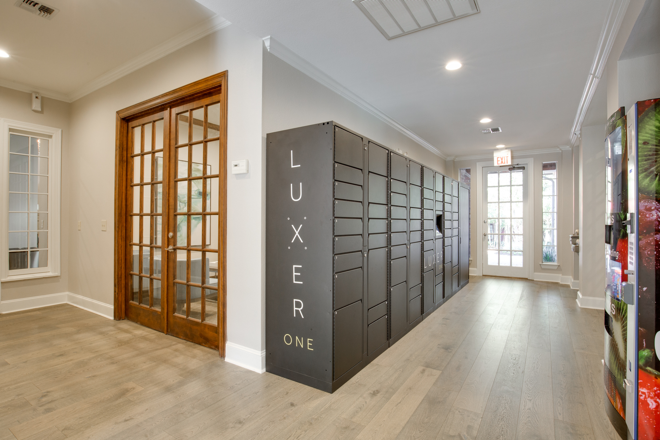 View of Luxer One Package Lockers with Wood Floors and Hallway at Raveneaux Apartments