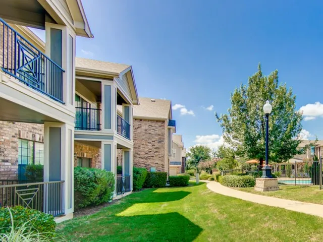 View of Building Exterior, Showing Landscaping and Private Patio or Balcony at Enclave on Golden Triangle Apartments