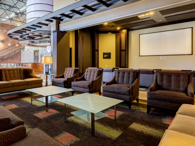 View of Movie Screening Lounge, Showing Seating Area and Projector Screen at The Melrose Apartments