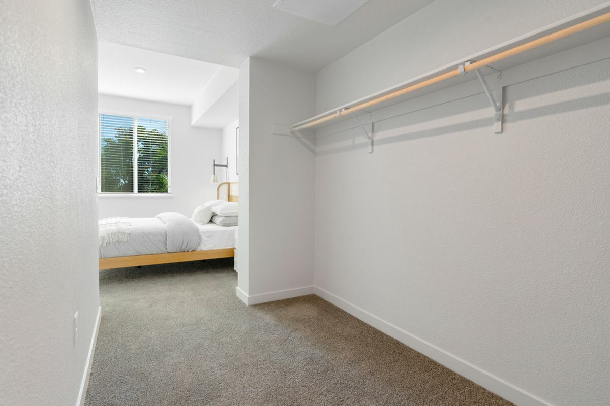 Inviting bedroom with plush carpeting, large windows, and ample closet space at 805 Riverfront.