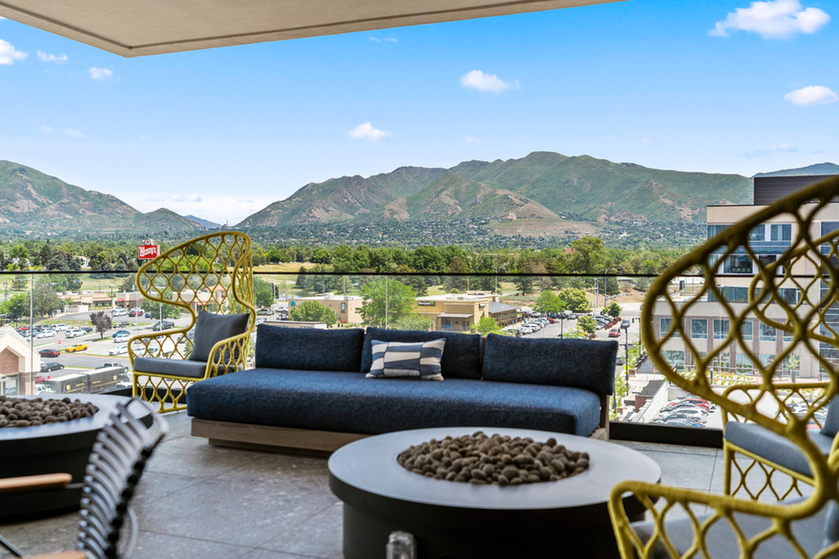 Elegant patio with modern seating and stunning mountain view, perfect for relaxation and entertaining.