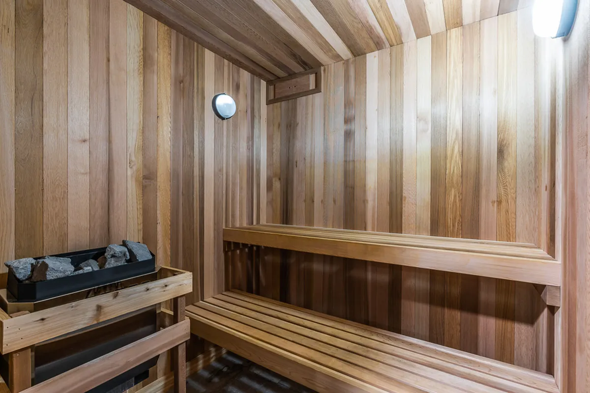Cozy wooden sauna room with warm lighting and comfortable seating.