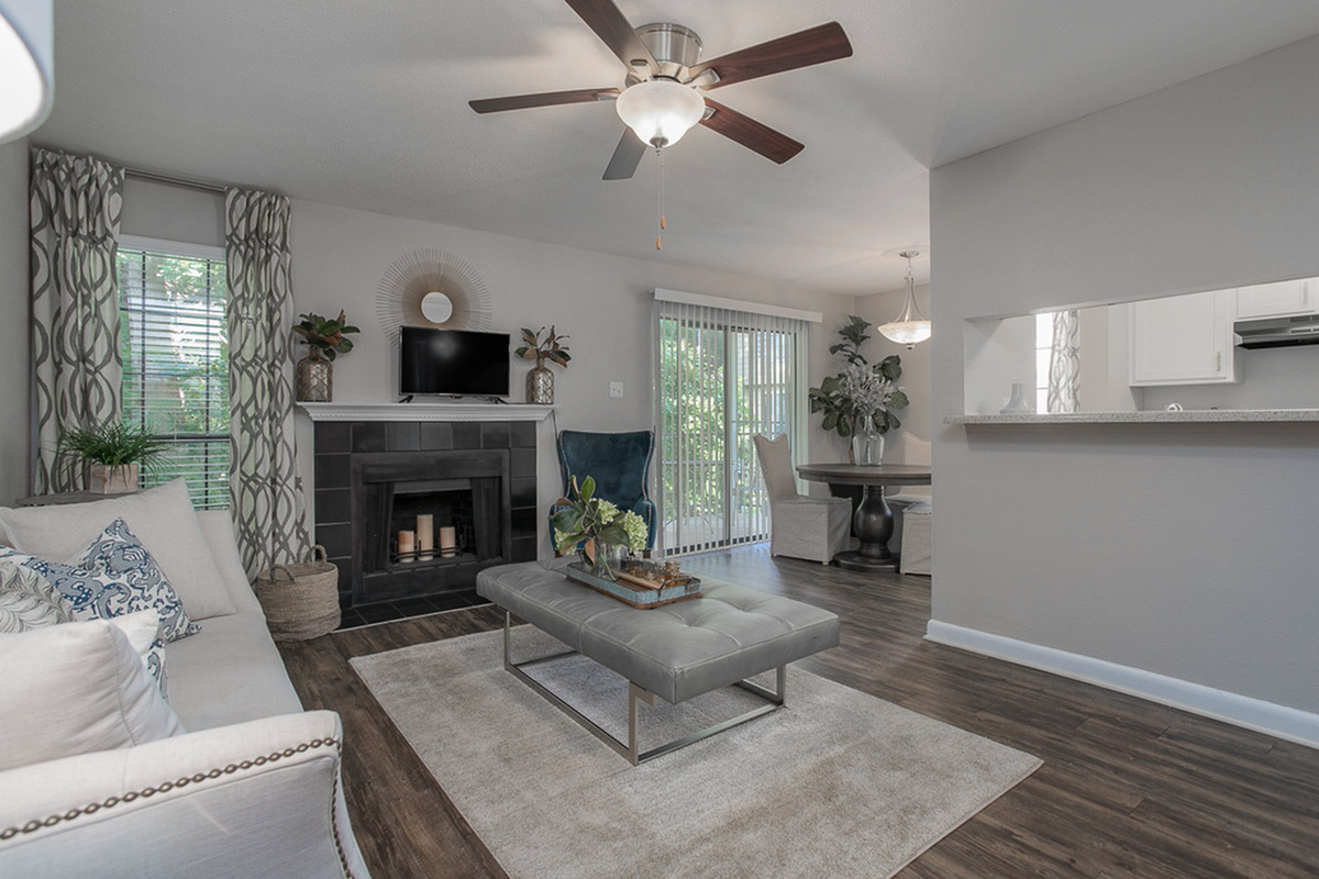 Elegant living room with a cozy fireplace, stylish decor, and an inviting open dining area, perfect for modern living.