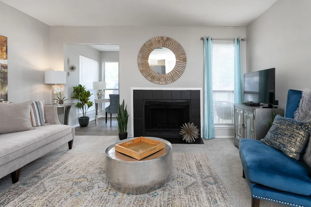 Contemporary living room with elegant seating, stylish decor, and a cozy fireplace, perfect for relaxation and entertaining.