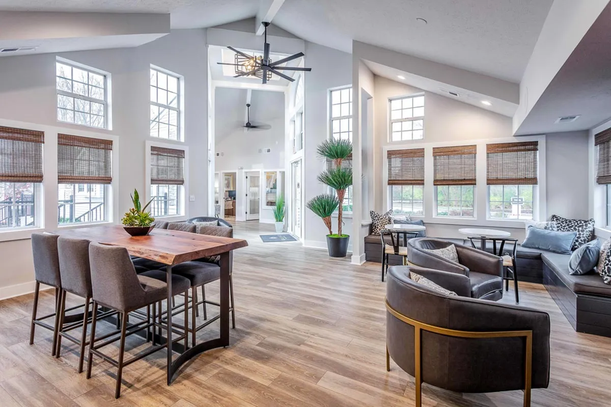 Inviting open-concept lounge area with modern seating, natural light, and stylish decor.