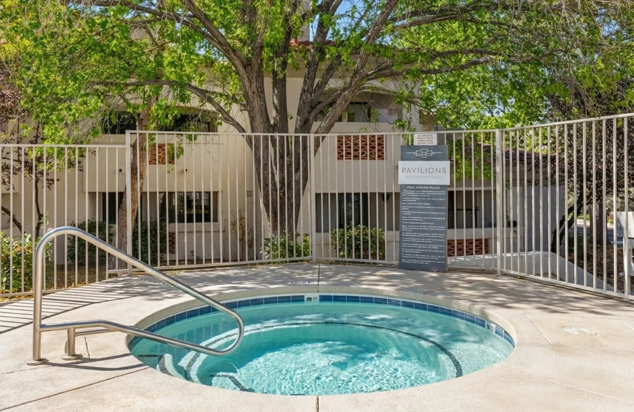 Inviting spa area surrounded by lush greenery at The Pavilions, offering a serene and relaxing retreat at Pavilions Apartments.