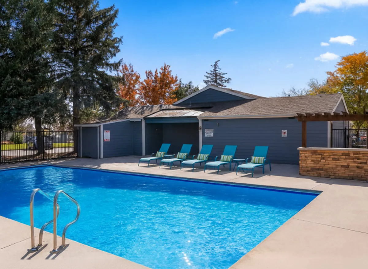 Inviting outdoor pool area with comfortable lounge chairs and scenic views, perfect for relaxation and leisure at Antero Apartments.