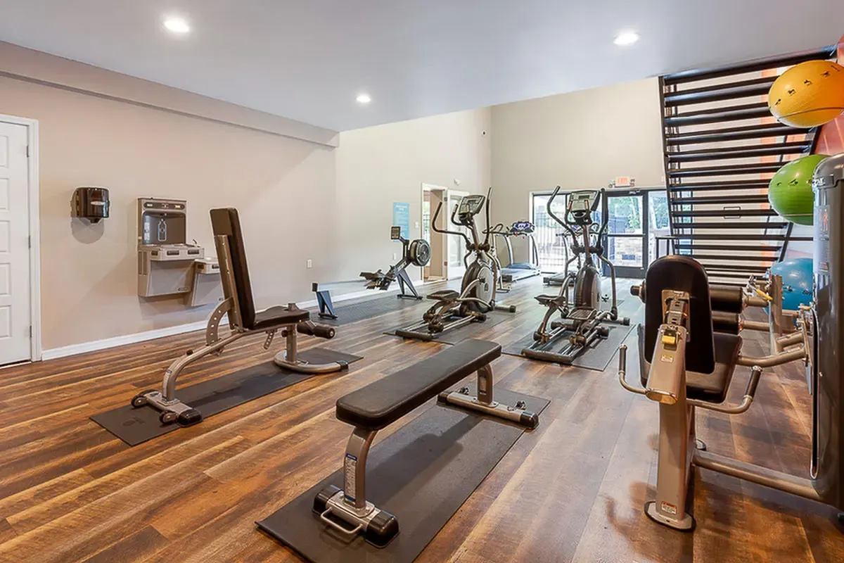 Modern fitness center at Park at Oak Ridge Apartments featuring state-of-the-art gym equipment and natural lighting, perfect for a healthy lifestyle.