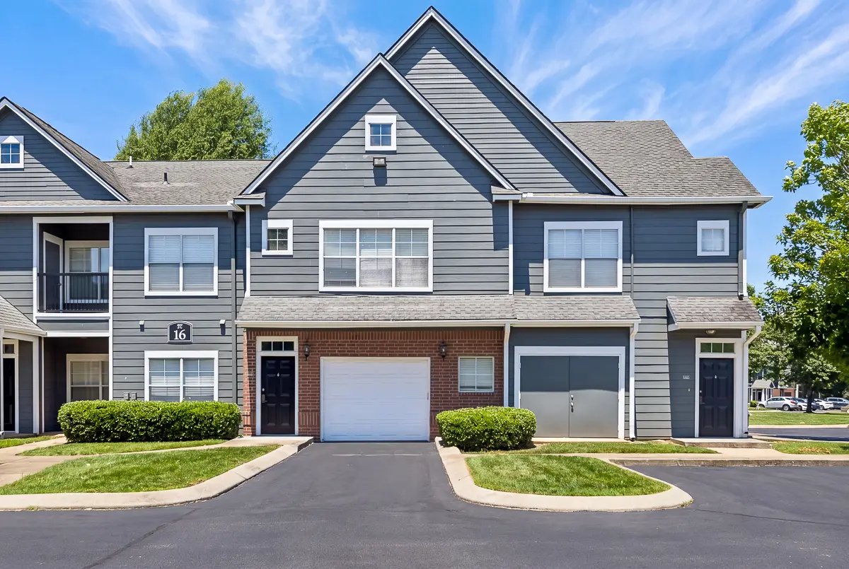 Charming townhouse exterior at Cason Estates Apartments in Murfreesboro, TN with modern aesthetic, featuring spacious garage, lush landscaping, and inviting entryway.