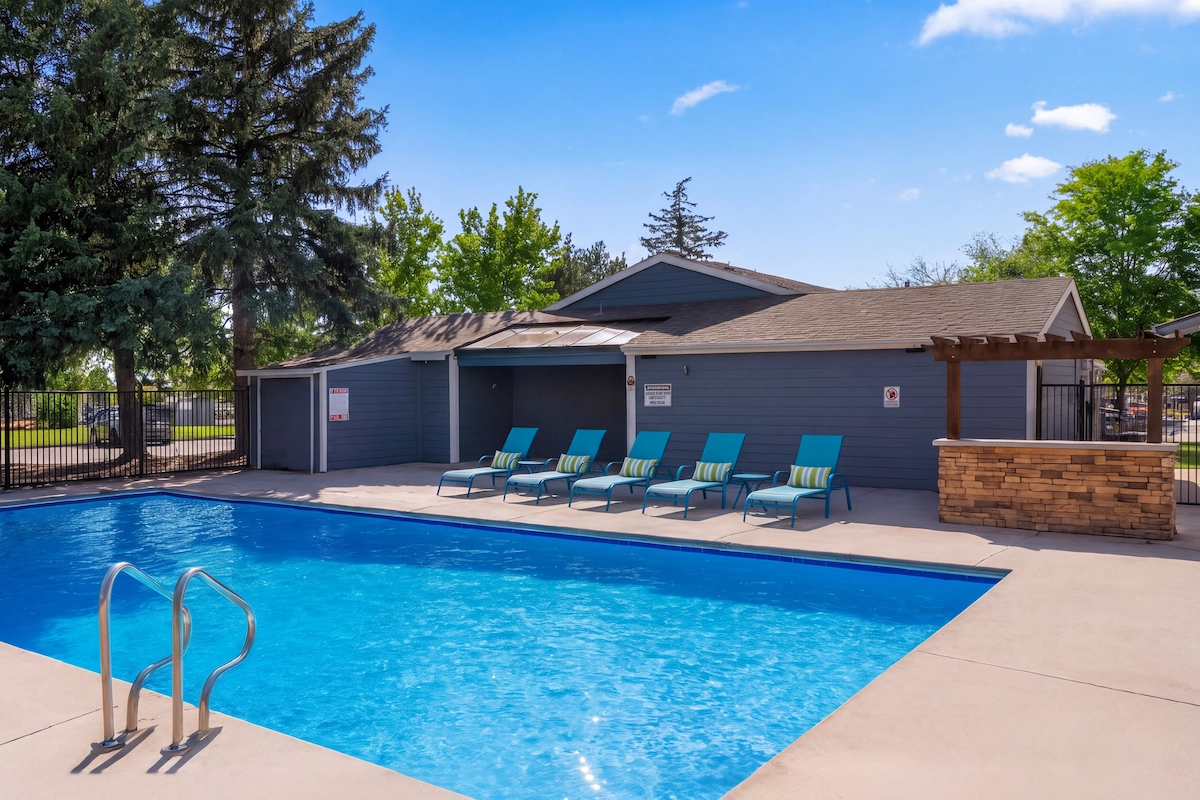 Inviting outdoor pool area with comfortable lounge chairs and scenic views, perfect for relaxation and leisure at Antero Apartments.